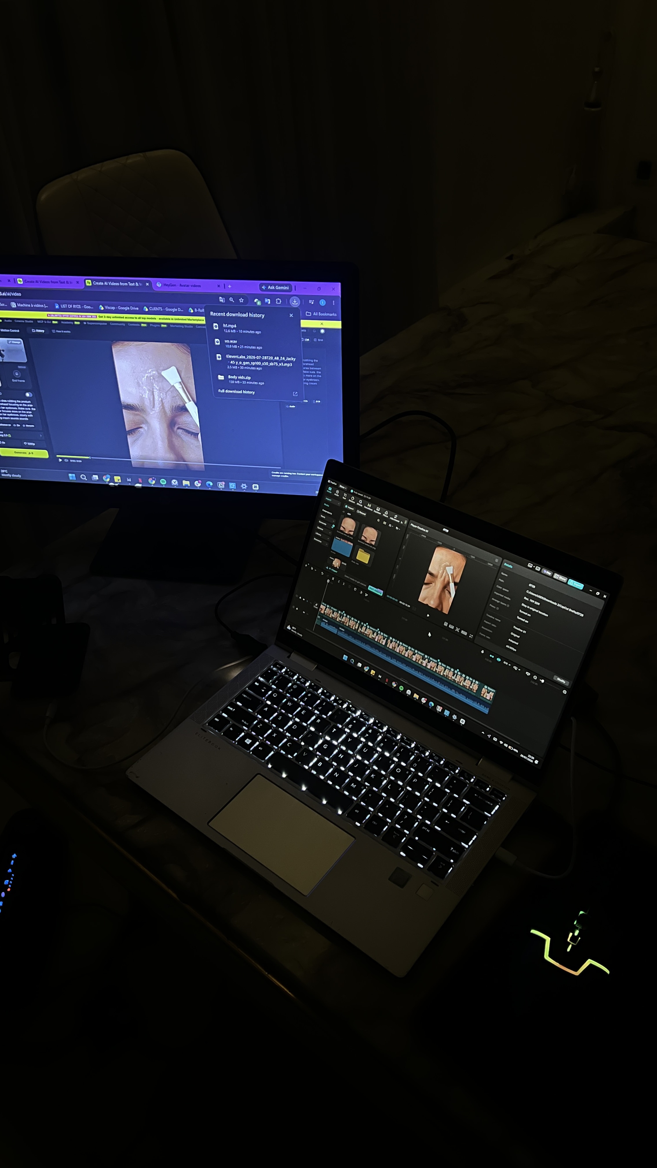 A laptop and external monitor displaying active video editing projects.